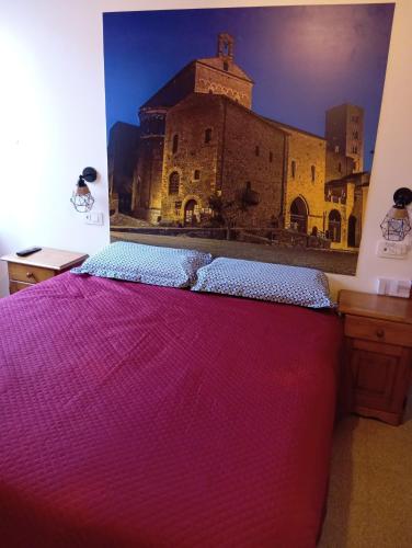 a bedroom with a bed with a painting of a building at Vicolo della Quiete Anagni in Anagni