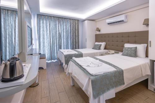 Кровать или кровати в номере Asli Hotel