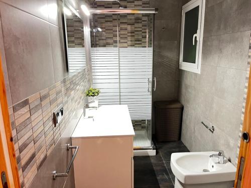 a bathroom with a sink and a toilet at Mirador mar in L'Ametlla de Mar