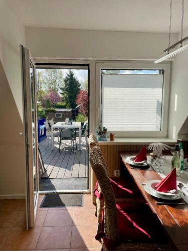 a kitchen with a sliding glass door to a patio at Ferienwohnung Paul in Papenburg