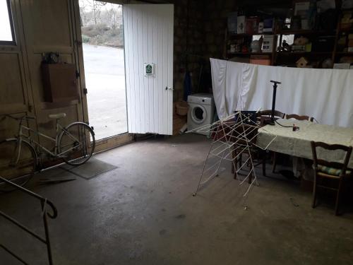 a room with a table and chairs and a door at Gîte Tante Aurore et chambres d'Hôtes in Chémery
