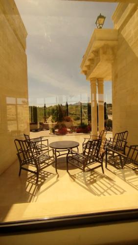 a group of chairs and a table on a patio at منتجع وفيلا تل الرمان in Ar Rummān