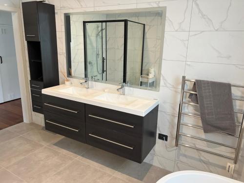 a bathroom with two sinks and a large mirror at Greytown Martinborough mansion in Greytown