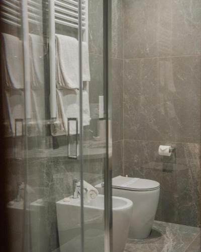 a bathroom with a white toilet and a sink at Hotel Piccola Vela in Desenzano del Garda