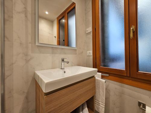 a bathroom with a white sink and a mirror at Hotel Guerrini in Venice