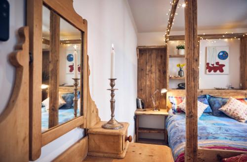 a bedroom with a bed and a mirror at Mountain Church in Capel-Curig
