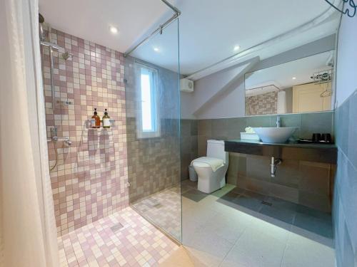 a bathroom with a shower and a toilet and a sink at Summer Station in Hualien City