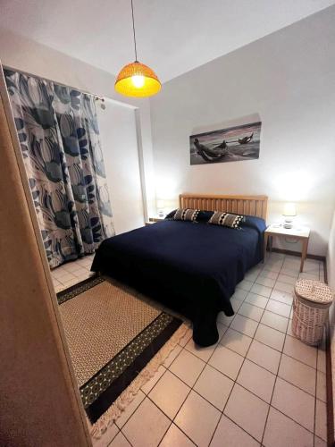 a bedroom with a bed with a black blanket at Sicily & Sun Letojanni Taormina in Letojanni