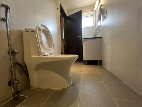 a bathroom with a toilet with the seat up at Hotel New Era in Kathmandu