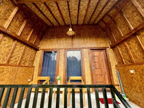 a room with a large window in a building at Azhani Bungalow in Tetebatu