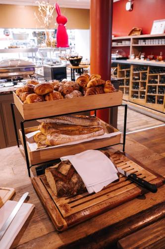 a display of bread and pastries in a bakery at Les Violettes Hotel & Spa in Jungholtz