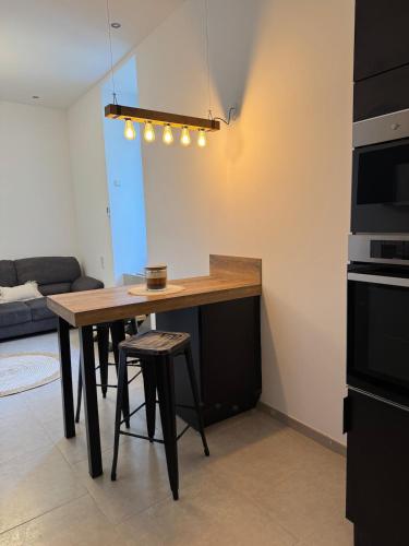 a kitchen with a table and stools in a room at Maison de village à Séguret in Séguret