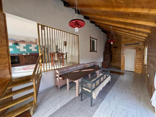 a dining room with a table and a staircase at Casa Adela in Neagra