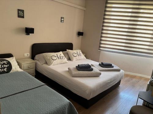 a bedroom with two beds and a window at Villa For You in Mostar