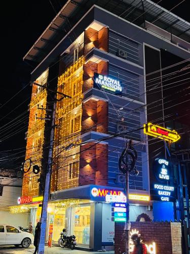 a building with neon signs on the side of it at Royal Mansion Hotel in Cochin