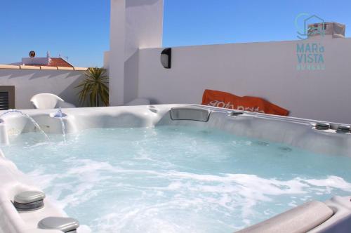 a jacuzzi bath tub in a room at Mar à Vista Burgau in Burgau