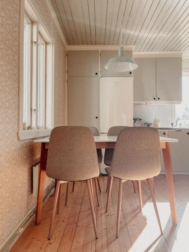 a kitchen with a table and two chairs at Charming house with wood stove near lake in Virserum