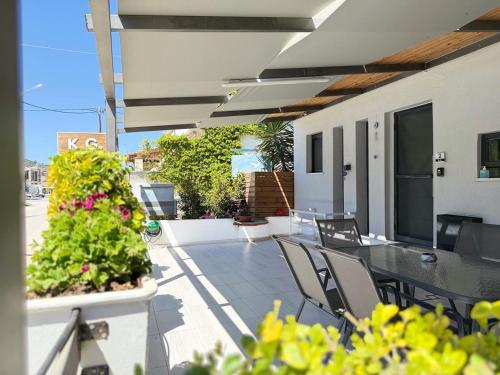 a balcony with a table and chairs on a building at K.G APARTMENT 2 in Pefkohori