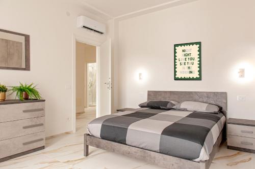 a bedroom with a large bed and a dresser at SEASIDE LOFT - 3 camere,2 bagni a 300 mt dal mare in Marina di Massa