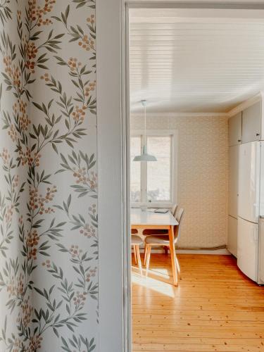 a kitchen and dining room with a dining table at Charming house with wood stove near lake in Virserum
