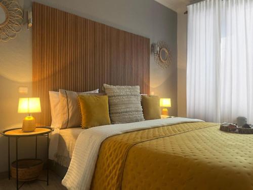 a bedroom with a large bed and a window at Casa da Susy do Alvão in Vila Real