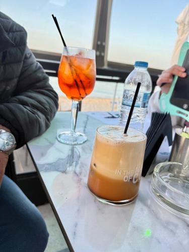 two drinks are sitting on a table at K.G APARTMENT 2 in Pefkohori