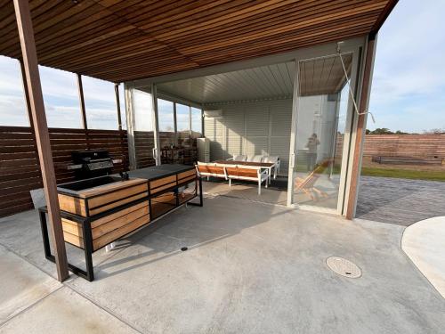 a glass pavilion with a table on a patio at VILLA Seamu 海風とどく広々贅沢GARDEN エアコン付きBBQルームを備えた高級ヴィラ in Kujukuri
