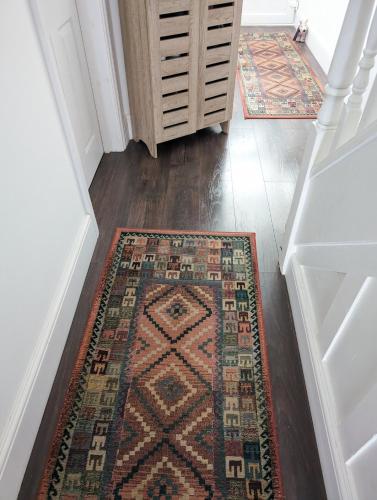 a hallway with an oriental rug on the floor at The Liddington in London