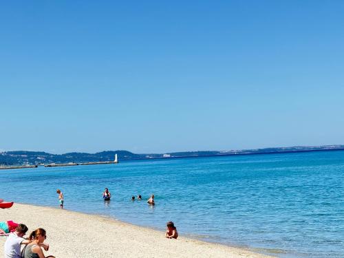 a group of people playing in the water at the beach at K.G APARTMENT 2 in Pefkohori
