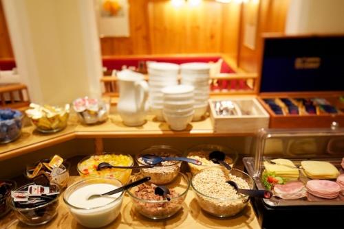 a counter top with a bunch of food on it at Pension Elisabeth in Westendorf