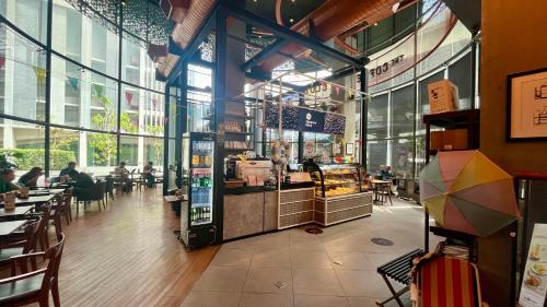 a restaurant with people sitting at tables in a building at 1BR Condo 5 Min to BTS 1000Mbps Fiber Wi-Fi great location in Bangkok