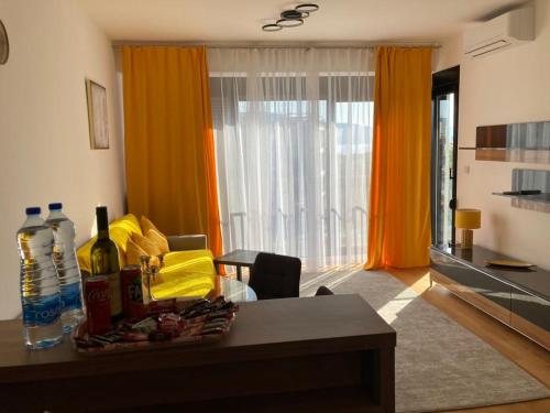 a living room with a table with wine bottles on it at Sears Residence Apartments in Tivat