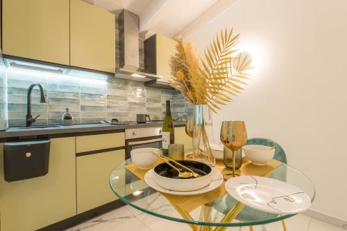 a kitchen with a glass table with wine glasses at Just Relax Home in Le Casette