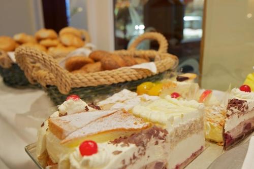 a table topped with different types of cakes and pastries at Pension Elisabeth in Westendorf
