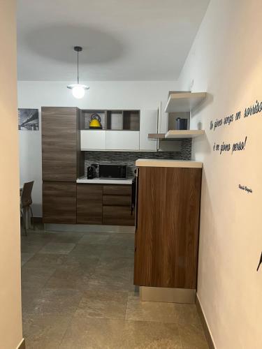 a kitchen with wooden cabinets and a counter top at GreenForum in Assago