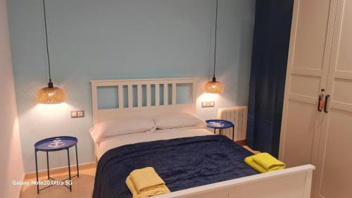 a bedroom with a bed with two stools and two lights at Vinaros Mar de Plata in Vinarós