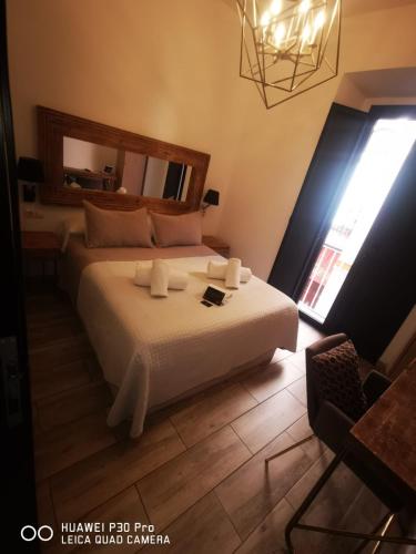 Ένα ή περισσότερα κρεβάτια σε δωμάτιο στο Center Suites San Eloy