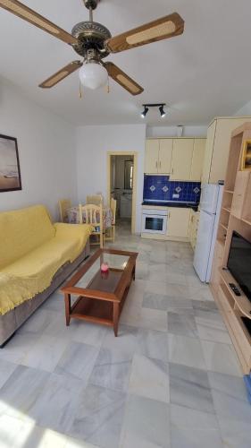 ein Wohnzimmer mit einer Couch und einem Tisch in der Unterkunft Vera Natura isleta nudista in Vera