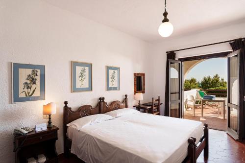 Una cama o camas en una habitación de Hotel Le Dune