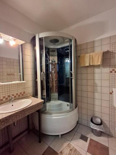 a bathroom with a shower and a sink at Pensiunea TOTAL Ceahlau in Ceahlău