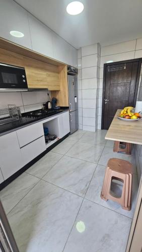 a kitchen with a counter with bananas on a table at Appartement Nador in Nador