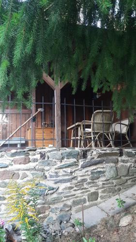 a house with a table and chairs sitting on a stone stairs at Chata Salicka Bozkov in Bozkov