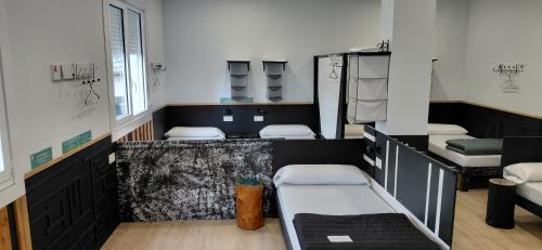 a room with three beds in a room at Albergue A ROTONDA in Redondela