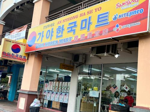 a store with a sign on the front of it at AGROWTH at Aru Suites in Kota Kinabalu