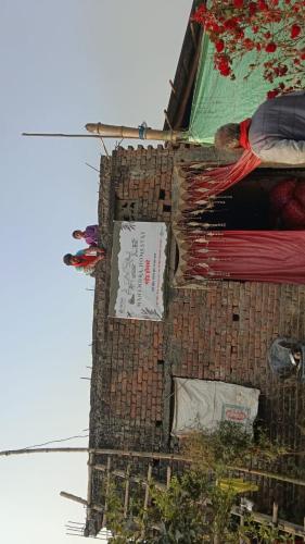 a tall brick building with papers on it at Mahendar Homestay in Nichlaul