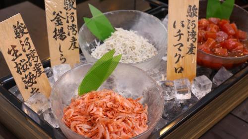 three bowls of food on a tray with rice at Dormy Inn Mishima in Mishima