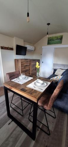 a wooden table with two plates on it in a room at The Studio in New Romney