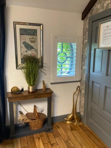 a hallway with a table and a window at Ballybur Lodge Mews 2 in Kilkenny