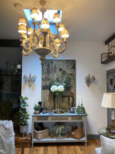 a chandelier in a living room with a table at Ballybur Lodge Mews 2 in Kilkenny