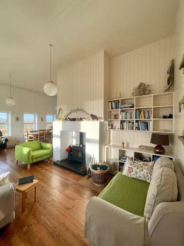 a living room with a couch and a fireplace at Belmullet Beach House Retreat in Belmullet